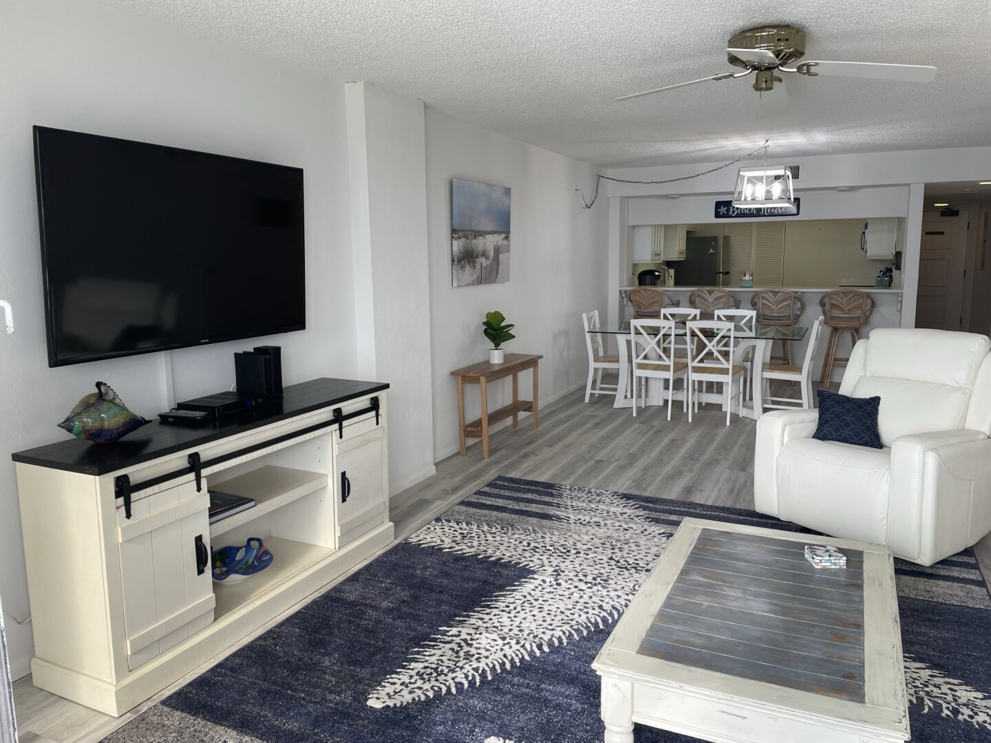 Open living room with television, recliners and oceanfront windows