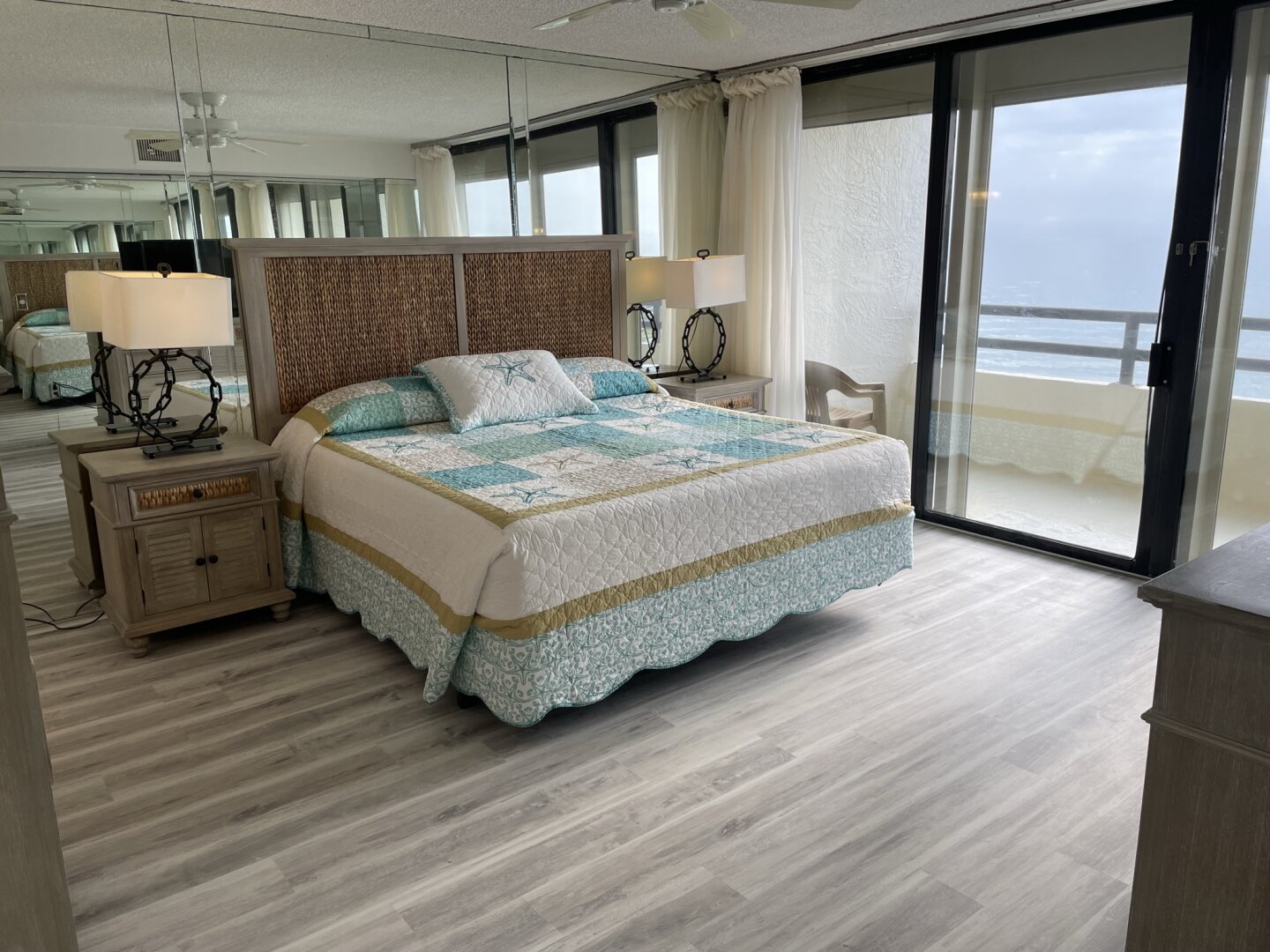 Primary bedroom with king bed and oceanfront balcony access